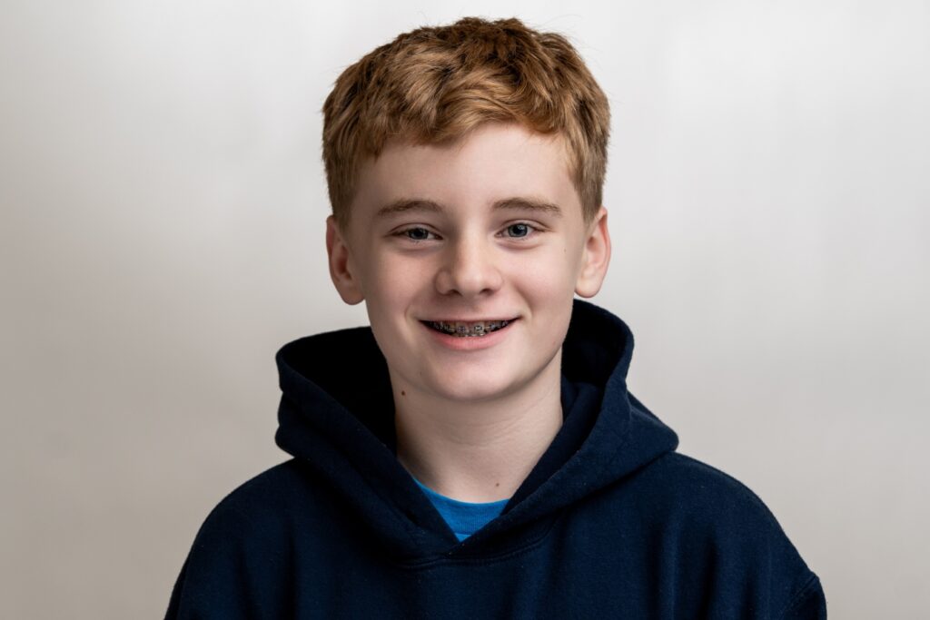 Young boy wearing braces smiling