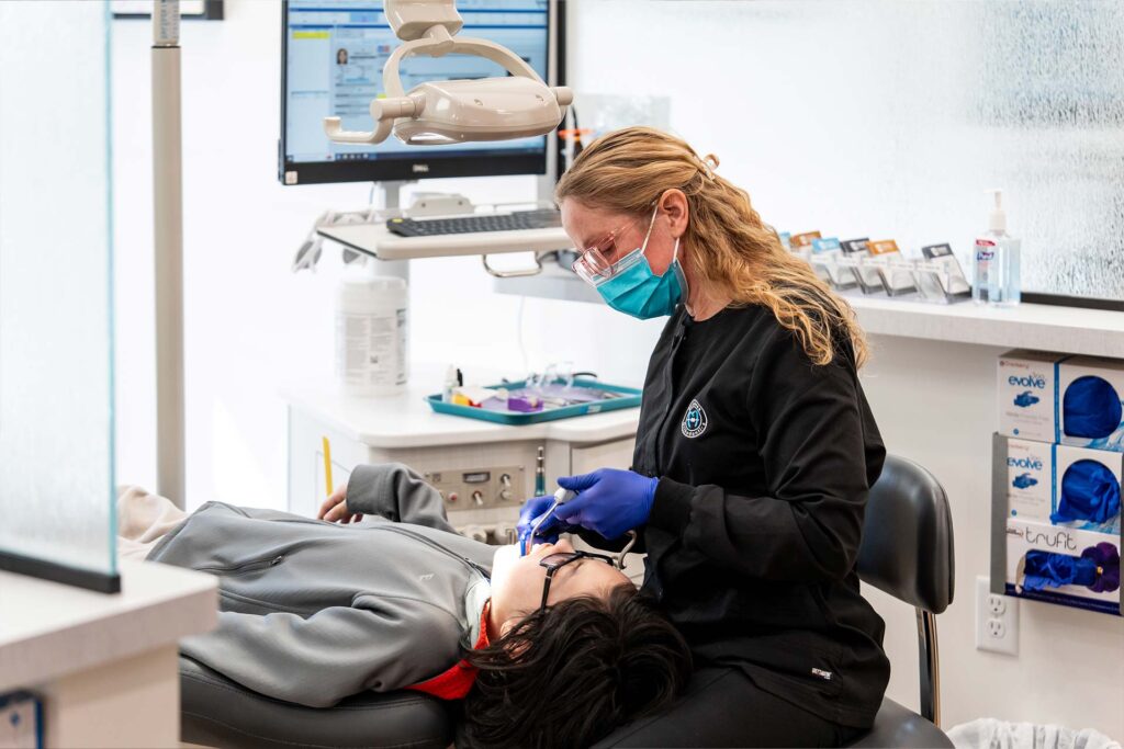 Orthodontic assistant adjusting a patient's braces at Dutchess Orthodontics